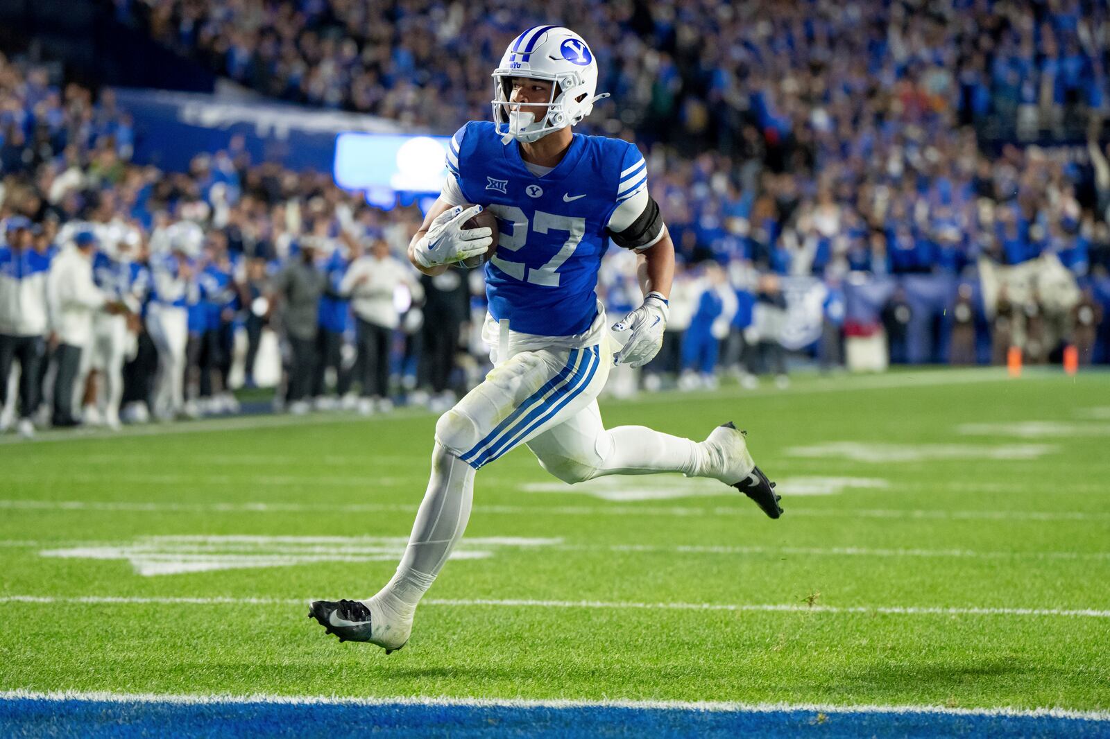 BYU running back LJ Martin runs in for a touchdown in the second half of an NCAA college football game against Oklahoma State, Friday, Oct. 18, 2024, in Provo, Utah. (AP Photo/Spenser Heaps)