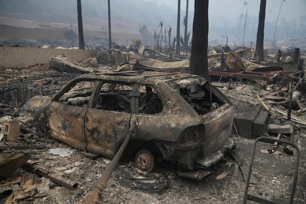 The Palisades Fire ravages a neighborhood amid high winds in the Pacific Palisades neighborhood of Los Angeles, Wednesday, Jan. 8, 2025. (AP Photo/Damian Dovarganes)