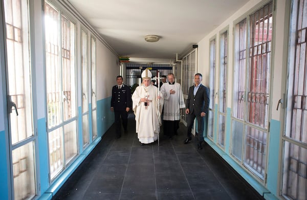 FILE - In this April 2, 2015 pool photo Pope Francis, center, holds the pastoral staff as he arrives for a Holy Thursday homily in the Rebibbia prison chapel in Rome. (AP Photo/L'Osservatore Romano, Pool, File)