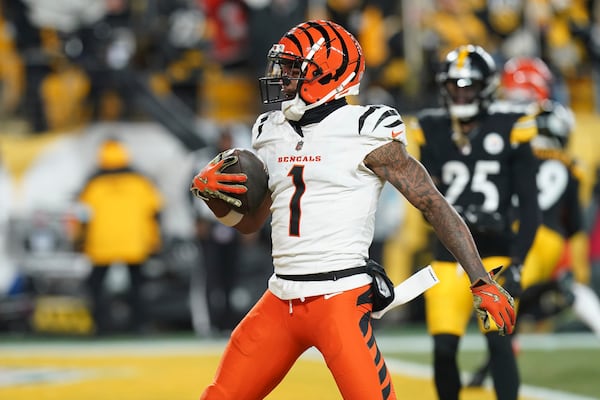 Cincinnati Bengals wide receiver Ja'Marr Chase (1) celebrates a touchdown during the first half of an NFL football game against the Pittsburgh Steelers in Pittsburgh, Saturday, Jan. 4, 2025. (AP Photo/Matt Freed)