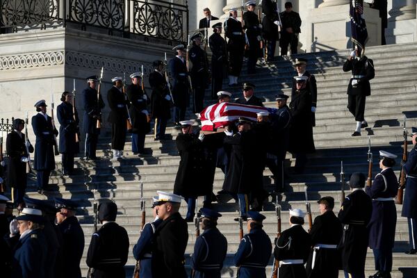 A joint services body bearer team carries the flag-draped casket of former President Jimmy Carter from the U.S. Capitol in Washington, Thursday, Jan. 9, 2025, to head to Washington National Cathedral for a State Funeral. (AP Photo/Susan Walsh, Pool)