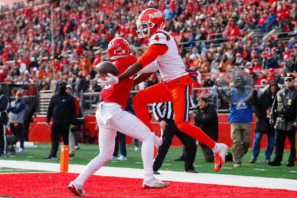 Illinois wide receiver Zakhari Franklin (4) can't maintain control of the ball as Rutgers defensive back Bo Mascoe (3) defends during the first half of an NCAA college football game, Saturday, Nov. 23, 2024, in Piscataway, N.J. (AP Photo/Rich Schultz)