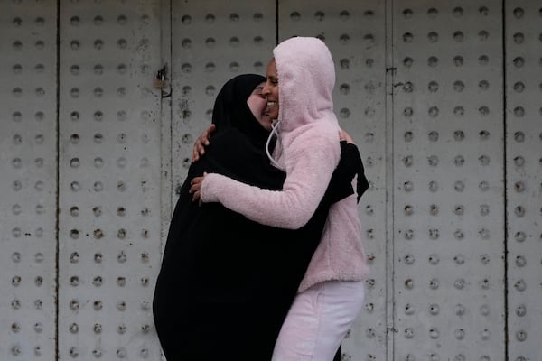 People hug each other upon their arrival at their building after the ceasefire between Hezbollah and Israel began early morning, in Tyre, south Lebanon, Wednesday, Nov. 27, 2024. (AP Photo/Hussein Malla)