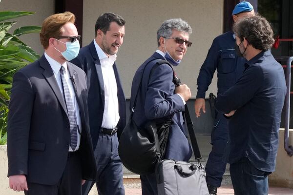 Former minister of interior Matteo Salvini, second from left, walks past Open Arms founder Oscar Camps, right, outside Palermo's court, Italy, Saturday, Oct. 23, 2021. (AP Photo/Gregorio Borgia, File)