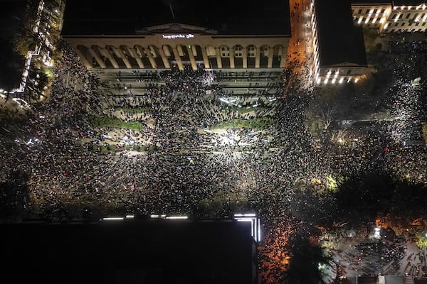 Demonstrators rally outside the parliament's building, top, to protest the government's decision to suspend negotiations on joining the European Union for four years in Tbilisi, Georgia, on Friday, Nov. 29, 2024. (AP Photo/Zurab Tsertsvadze)