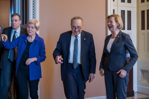 Senate Majority Leader Chuck Schumer, D-N.Y., center, is joined by, from left, Sen. Mark Warner, D-Va., Sen. Elizabeth Warren, D-Mass., and Sen. Tammy Baldwin, D-Wis., right, as they emerge from Democratic Caucus leadership elections, at the Capitol in Washington, Tuesday, Dec. 3, 2024. (AP Photo/J. Scott Applewhite)