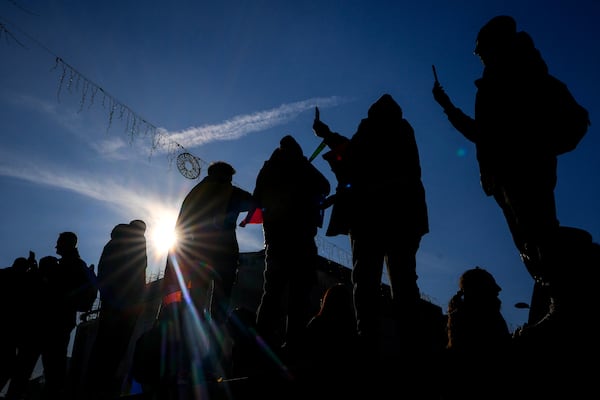 Protesters film with their mobile phones during a rally organized by the right wing Alliance for the Unity of Romanians (AUR), calling for free elections after Romania' s Constitutional Court annulled the first round of presidential elections last December, in Bucharest, Romania, Sunday, Jan. 12, 2025. (AP Photo/Vadim Ghirda)