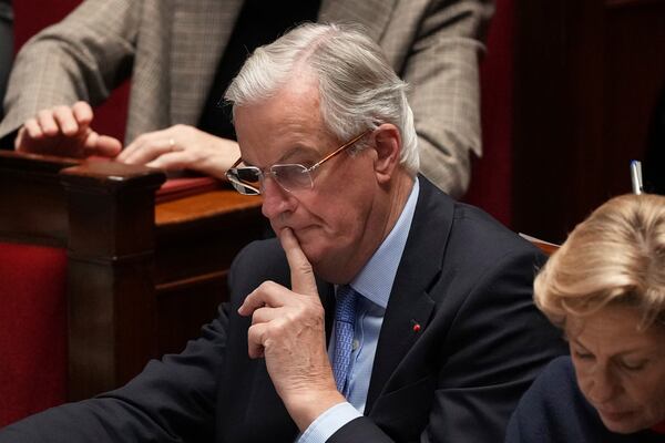 French Prime Minister Michel Barnier listens to speeches at the National Assembly prior to a no-confidence vote that could bring down the Prime Minister and the government for the first time since 1962, Wednesday, Dec. 4, 2024 in Paris. (AP Photo/Michel Euler)