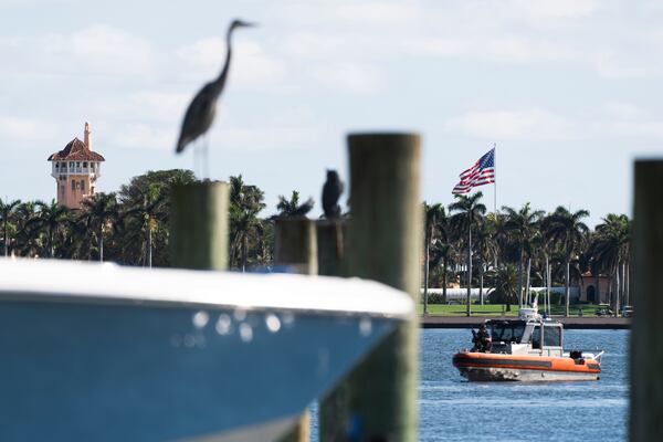 The U.S. flag is shown at Mar-a-Lago compound in Palm Beach, Fla., while a U.S. Coast Guard boat patrols around the vicinity, Monday, Jan. 13, 2025. U.S. flags at President-elect Donald Trump's private Mar-a-Lago club are back to flying at full height. Flags are supposed to fly at half-staff through the end of January out of respect for former President Jimmy Carter, who died Dec. 29. (AP Photo/Manuel Balce Ceneta)