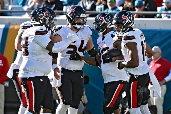 Houston Texans running back Joe Mixon, second from right, celebrates his touchdown run against the Jacksonville Jaguars with teammates, including center Jarrett Patterson (54) during the second half of an NFL football game Sunday, Dec. 1, 2024, in Jacksonville, Fla. (AP Photo/Phelan M. Ebenhack)