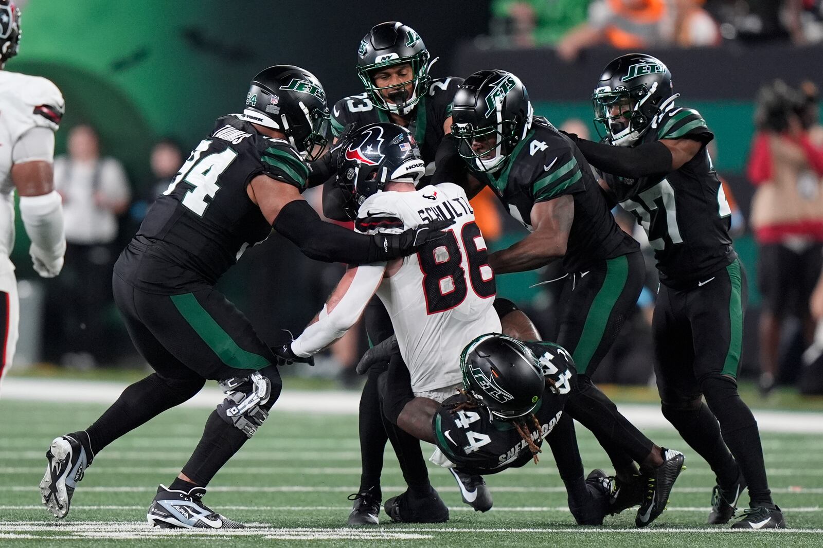 New York Jets linebacker Jamien Sherwood (44) and teammates tackle Houston Texans tight end Dalton Schultz (86) during the second half of an NFL football game Thursday, Oct. 31, 2024, in East Rutherford, N.J. (AP Photo/Frank Franklin II)