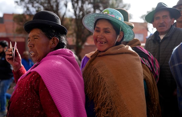 Aymara women wait in line to cast their ballots at a polling station during judicial elections in Jesus de Machaca, Bolivia, Sunday, Dec. 15, 2024. (AP Photo/Juan Karita)