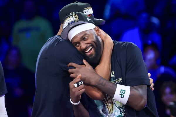 Milwaukee Bucks forwards Giannis Antetokounmpo (34) and Bobby Portis (9) hug after their team's victory in the championship game of the NBA Cup basketball tournament against the Oklahoma City Thunder Tuesday, Dec. 17, 2024, in Las Vegas. (AP Photo/Ian Maule)