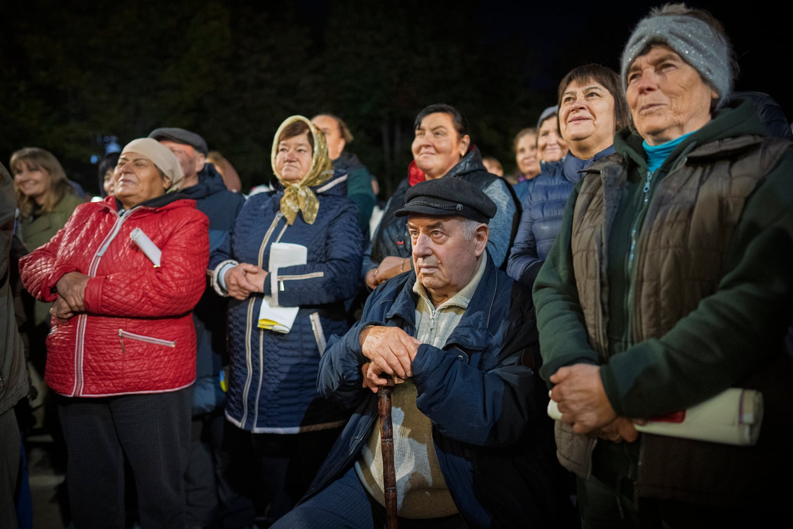 People listen to Moldova's President Maia Sandu speaking in Magdacesti, Moldova, Thursday, Oct. 17, 2024, as she seeks a second term in office ahead of a presidential election and a referendum of whether to enshrine in Moldova's Constitution its path to European Union membership taking place on Oct.20. (AP Photo/Vadim Ghirda)