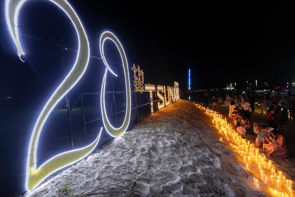 Relatives of victims of the 2004 Indian Ocean tsunami hold a candle light vigil as they participate in the 20th anniversary, at Tsunami Memorial Park at Ban Nam Khem, Takuapa district of Phang Nga province, southern Thailand, Thursday, Dec. 26, 2024. (AP Photo/Wason Wanichakorn)