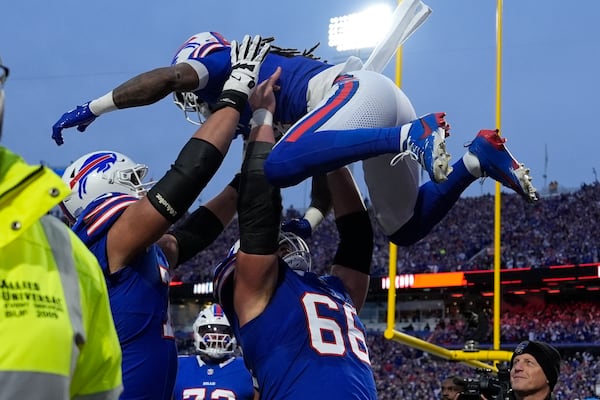 Buffalo Bills running back James Cook is lifted by teammate Connor McGovern (66) after scoring during the first half of an NFL football game against the Kansas City Chiefs Sunday, Nov. 17, 2024, in Orchard Park, N.Y. (AP Photo/Julia Demaree Nikhinson)