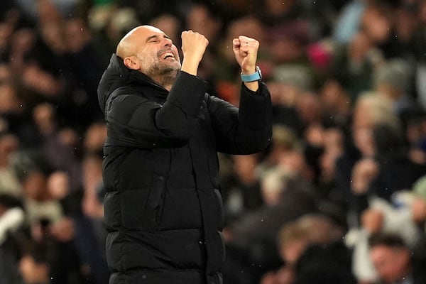 Manchester City manager Pep Guardiola reacts after Manchester City's Jeremy Doku scores his sides third goal during a Premier League soccer match against Nottingham Forest at the Etihad Stadium, Wednesday, Dec. 4, 2024, in Manchester, England. (Martin Rickett/PA via AP)