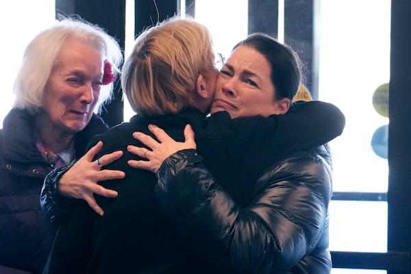 Former Olympic skater Nancy Kerrigan, right, is embraced while arriving at The Skating Club of Boston with fellow Olympic skater Tenley Albright, left, Thursday, Jan. 30, 2025, in Norwood, Mass. (AP Photo/Charles Krupa)