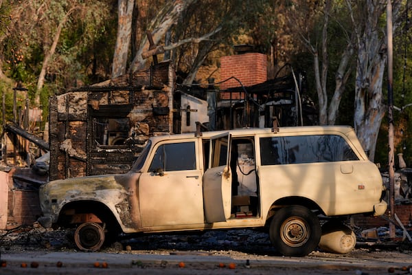 A car damaged by the Eaton Fire is seen Thursday, Jan. 16, 2025, in Altadena, Calif. (AP Photo/Carolyn Kaster)