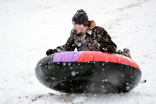 Wyatt Block sleds down a hill in the snow Friday, Jan. 10, 2025, in Nashville, Tenn. (AP Photo/George Walker IV)