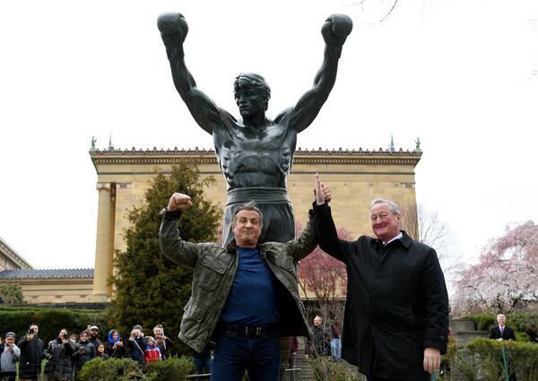 FILE - Sylvester Stallone, left, poses with Philadelphia Mayor Jim Kenney in front of the Rocky statue at the Philadelphia Art Museum for a "Creed II" photo op, Friday, April 6, 2018, in Philadelphia.(AP Photo/Michael Perez)