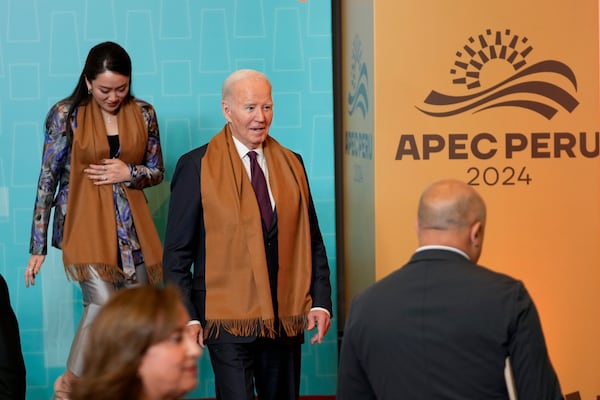 President Joe Biden walks off the stage after the taking of the leaders' group photo, during the Asia-Pacific Economic Cooperation (APEC) summit, in Lima, Peru, Saturday, Nov. 16, 2024. (AP Photo/Fernando Vergara)