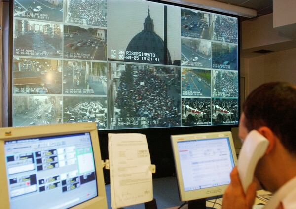 FILE - Live signals from the Vatican, St. Peter's Basilica, and the surrounding streets are seen in the control room at the municipal police headquarters in Rome, Wednesday, April 6, 2005. (AP Photo/Corrado Giambalvo, File)