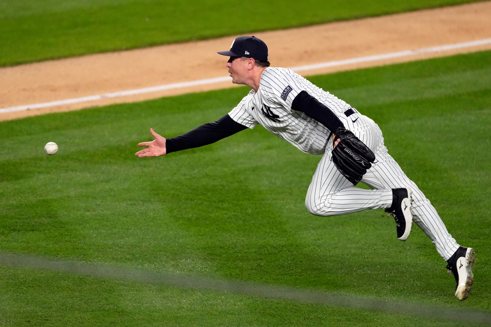 New York Yankees pitcher Mark Leiter Jr. tosses the ball to catcher Jose Trevino during the fourth inning in Game 3 of the baseball World Series, Monday, Oct. 28, 2024, in New York. Trevino tagged Los Angeles Dodgers' Gavin Lux out at home. (AP Photo/Seth Wenig)