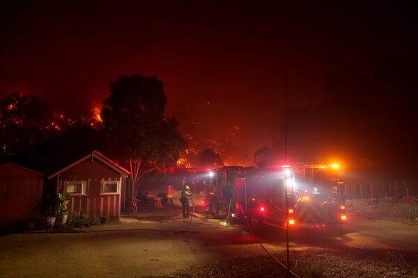 Firefighters protect a structure as the Franklin Fire approaches in Malibu, Calif., Tuesday, Dec. 10, 2024. (AP Photo/Eric Thayer)