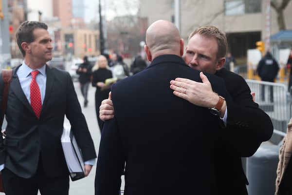 Andrew Giuliani hugs attorney Joseph Cammarata outside of federal court, Thursday, Jan. 16, 2025, in New York. (AP Photo/Heather Khalifa)