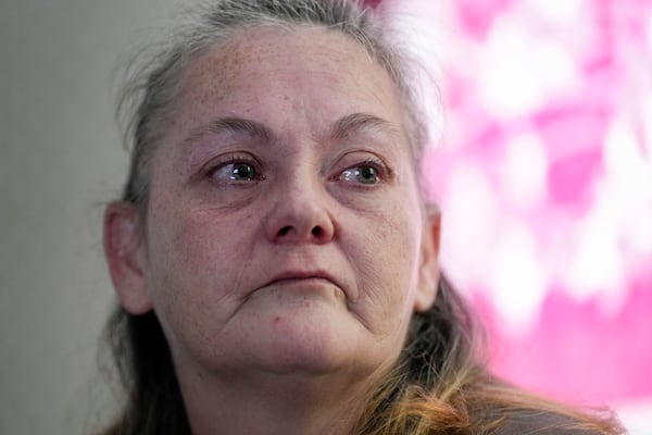 Zinnia Adkins reflects on her experience during Hurricane Helene in September at her home on Nov. 22, 2024, in Unicoi, Tenn. Adkins escaped flood waters at the plastics factory where she worked. (AP Photo/George Walker IV)