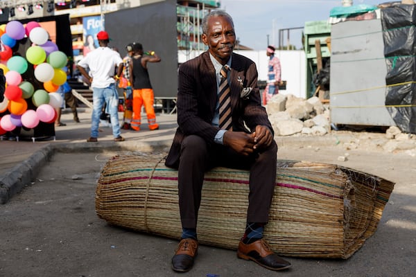 A man dressed in second-hand clothes attends a thrift and an upcycle show in Accra, Ghana, Sunday, Oct. 27, 2024. (AP Photo/Misper Apawu)