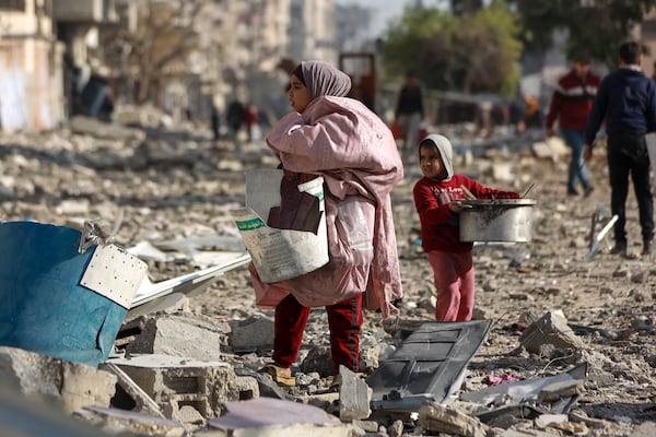 Palestinians inspect the destruction caused by the Israeli air and ground offensive in Jabaliya, as a ceasefire deal between Israel and Hamas went into effect, Sunday, Jan. 19, 2025. (AP Photo/Abed Hajjar)