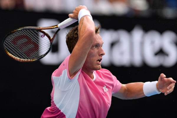 Jiri Lehecka of the Czech Republic returns a shot from Novak Djokovic of Serbia during their fourth round match at the Australian Open tennis championship in Melbourne, Australia, Sunday, Jan. 19, 2025. (AP Photo/Asanka Brendon Ratnayake)