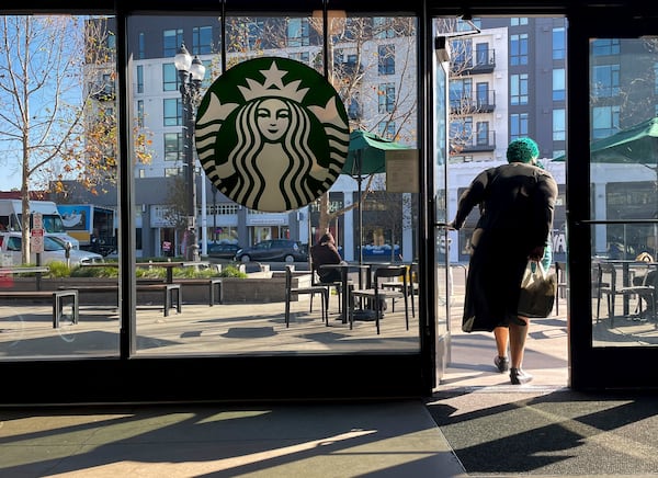 A costumer exits a Starbucks store in Oakland, Calif., Thursday, Jan. 16, 2025. (AP Photo/Godofredo A. Vásquez)