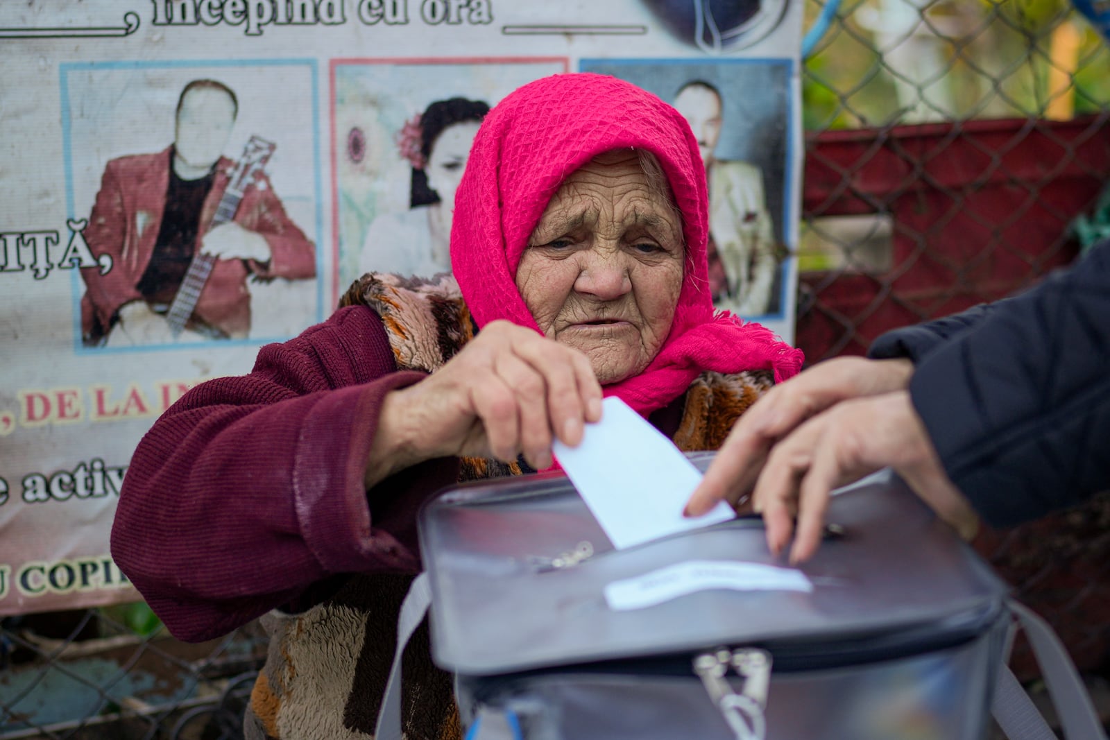 A woman casts her vote in a mobile ballot box during a presidential election runoff, in the village of Ciopleni, Moldova, Sunday, Nov. 3, 2024. (AP Photo/Vadim Ghirda)