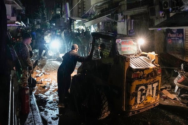 Rescue workers work at the site of an Israeli airstrike in Beirut, Lebanon, Monday, Nov. 18, 2024. (AP Photo/Bilal Hussein)