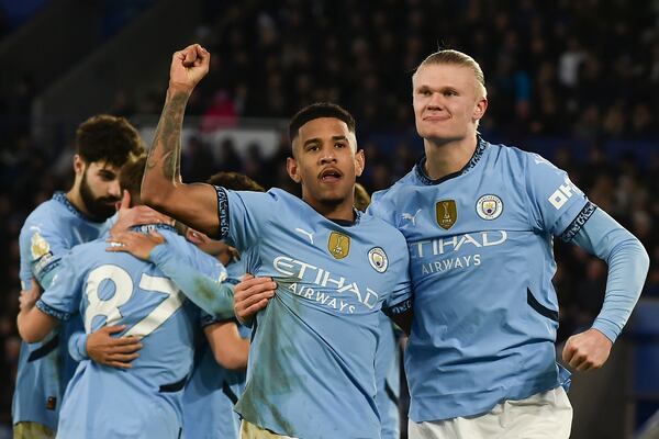 Manchester City's Erling Haaland, right, celebrates with Manchester City's Savinho after scoring his side's second goal during the English Premier League soccer match between Leicester City and Manchester City at King Power stadium in Leicester, England, Sunday, Dec. 29, 2024. (AP Photo/Rui Vieira)