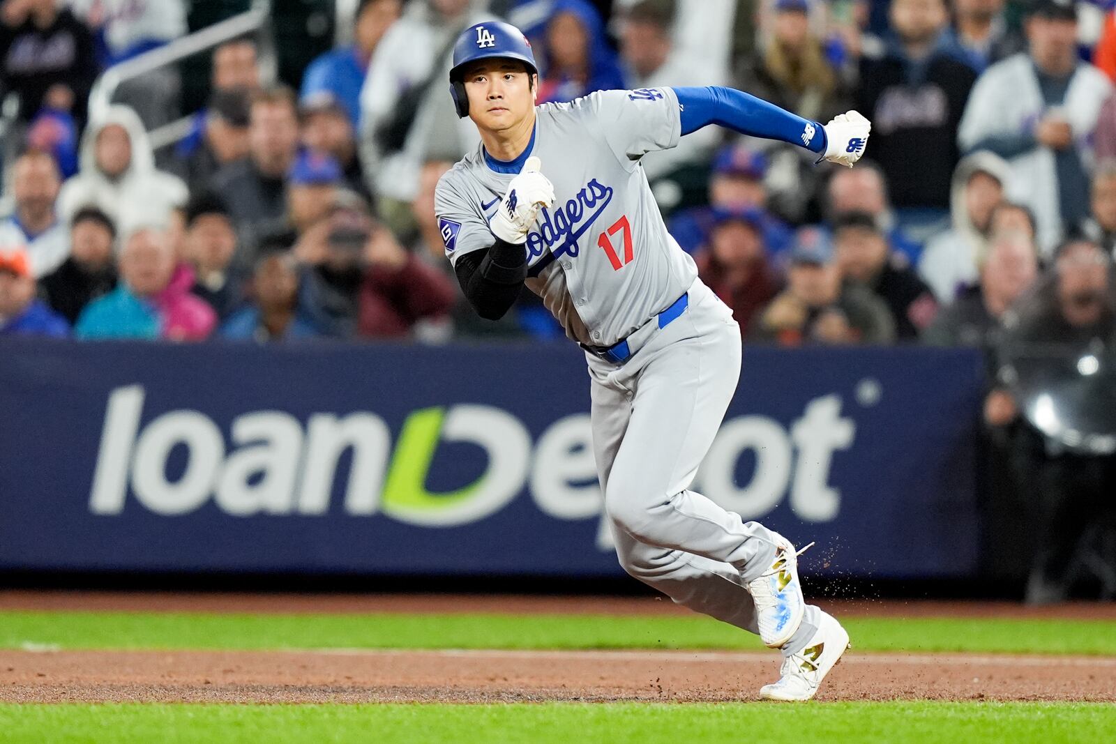 Los Angeles Dodgers' Shohei Ohtani runs to first during the third inning in Game 4 of a baseball NL Championship Series against the New York Mets, Thursday, Oct. 17, 2024, in New York. (AP Photo/Frank Franklin II)