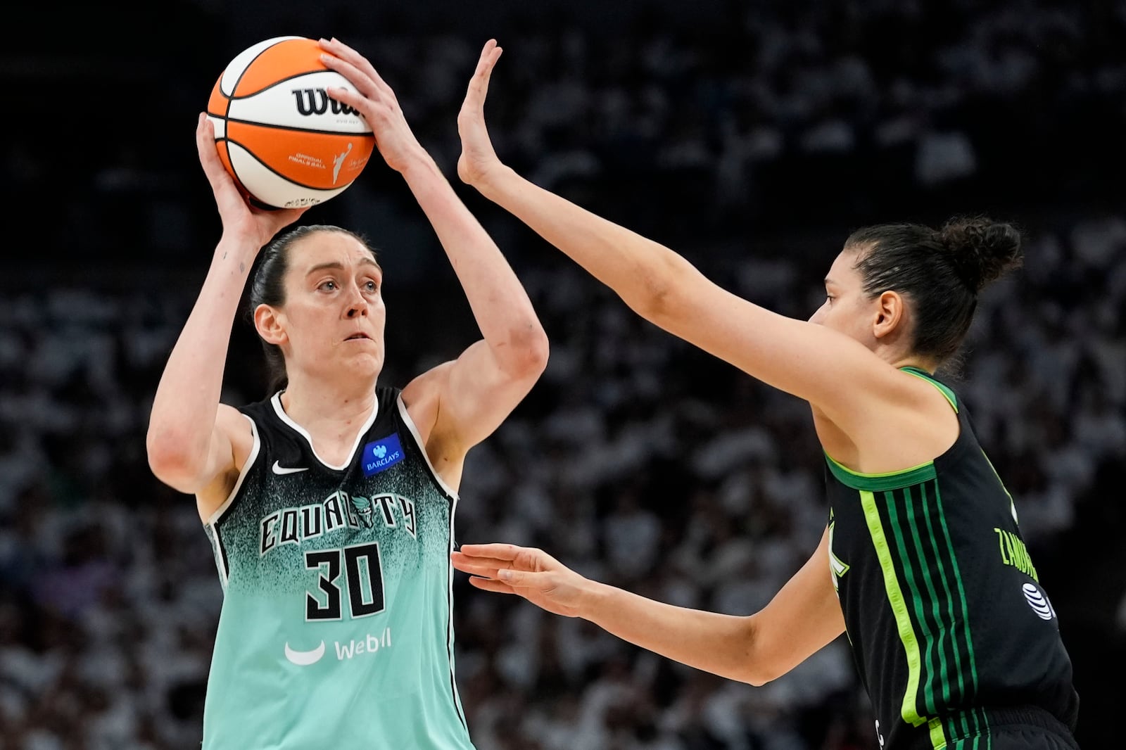 New York Liberty forward Breanna Stewart (30) shoots against Minnesota Lynx forward Cecilia Zandalasini (9) during the first half of Game 4 of a WNBA basketball final playoff series, Friday, Oct. 18, 2024, in Minneapolis. (AP Photo/Abbie Parr)