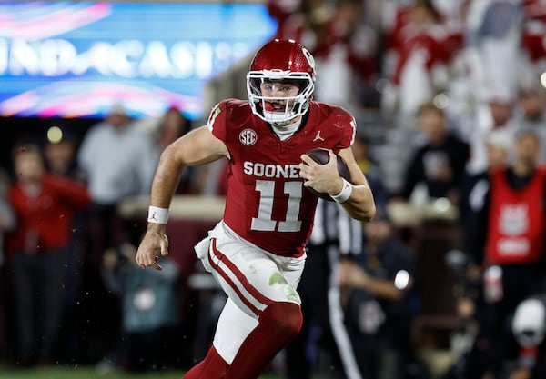 Oklahoma quarterback Jackson Arnold runs the ball during the second half of a NCAA college football game against Alabama, Saturday, Nov. 23, 2024, in Norman, Okla. (AP Photo/Alonzo Adams)