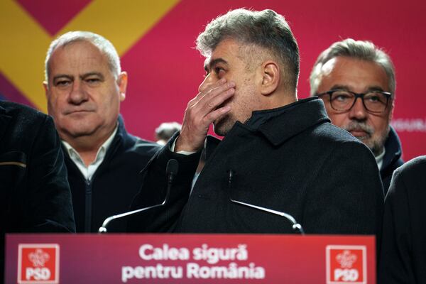 Romanian Prime Minister Marcel Ciolacu, the Social Democratic Party or PSD candidate in the country's presidential elections, wipes his face while watching exit polls after polls closed, in Bucharest, Romania, Sunday, Nov. 24, 2024. (AP Photo/Vadim Ghirda)