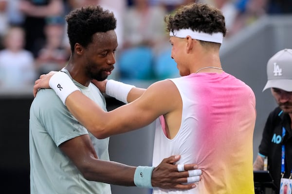 Ben Shelton, right, of the U.S. embraces Gael Monfils of France after Monfils retired during their fourth round match at the Australian Open tennis championship in Melbourne, Australia, Monday, Jan. 20, 2025. (AP Photo/Manish Swarup)