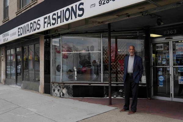 Ledall Edwards stands outside his family's men's clothing store, Edward's Fashions, which his father opened 50 years ago with the hopes of a southern Red Line train line expansion, Thursday, Dec. 19, 2024, in the Roseland neighborhood of Chicago. (AP Photo/Erin Hooley)