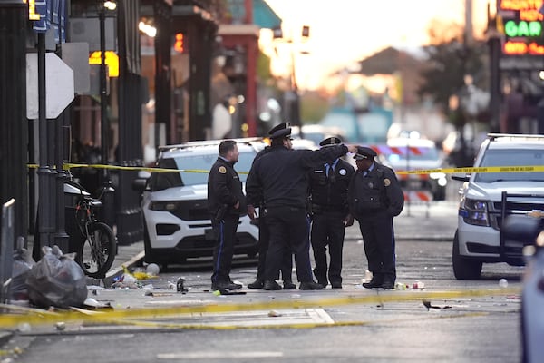 Emergency services attend the scene on Bourbon Street after a vehicle drove into a crowd on New Orleans' Canal and Bourbon Street, Wednesday Jan. 1, 2025. (AP Photo/Gerald Herbert)