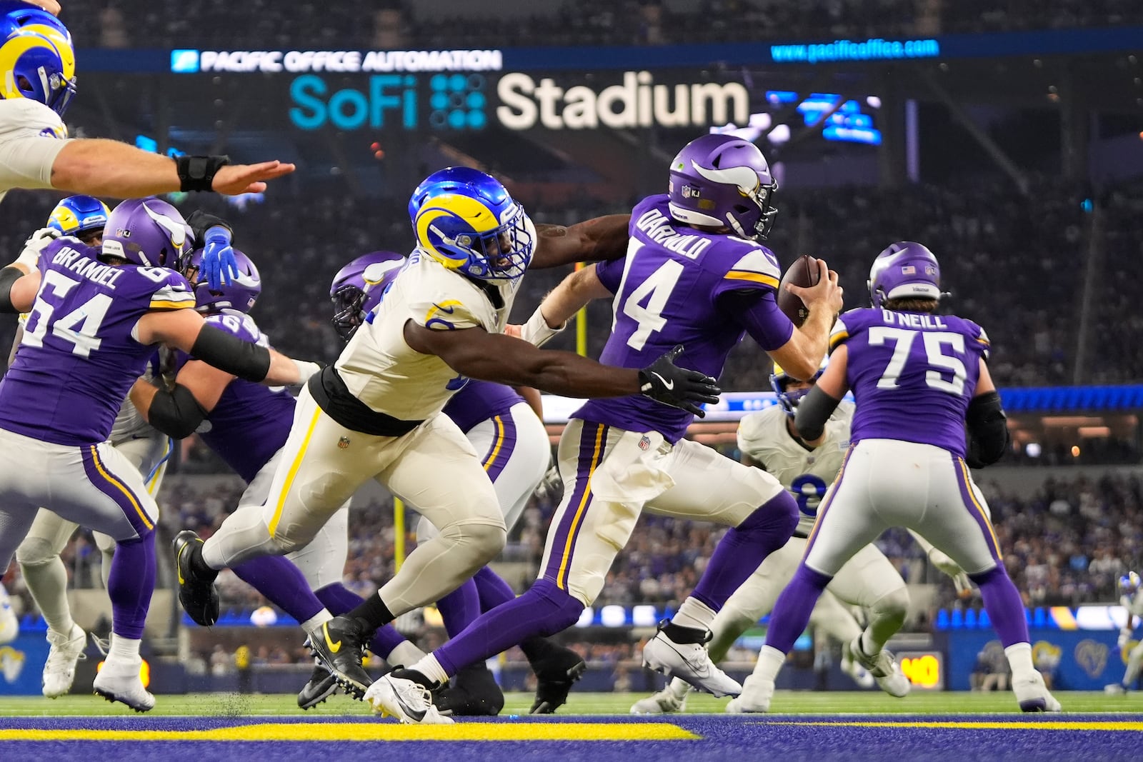 Minnesota Vikings quarterback Sam Darnold (14) is sacked for a safety by Los Angeles Rams linebacker Byron Young, center left, during the second half of an NFL football game, Thursday, Oct. 24, 2024, in Inglewood, Calif. (AP Photo/Mark J. Terrill)