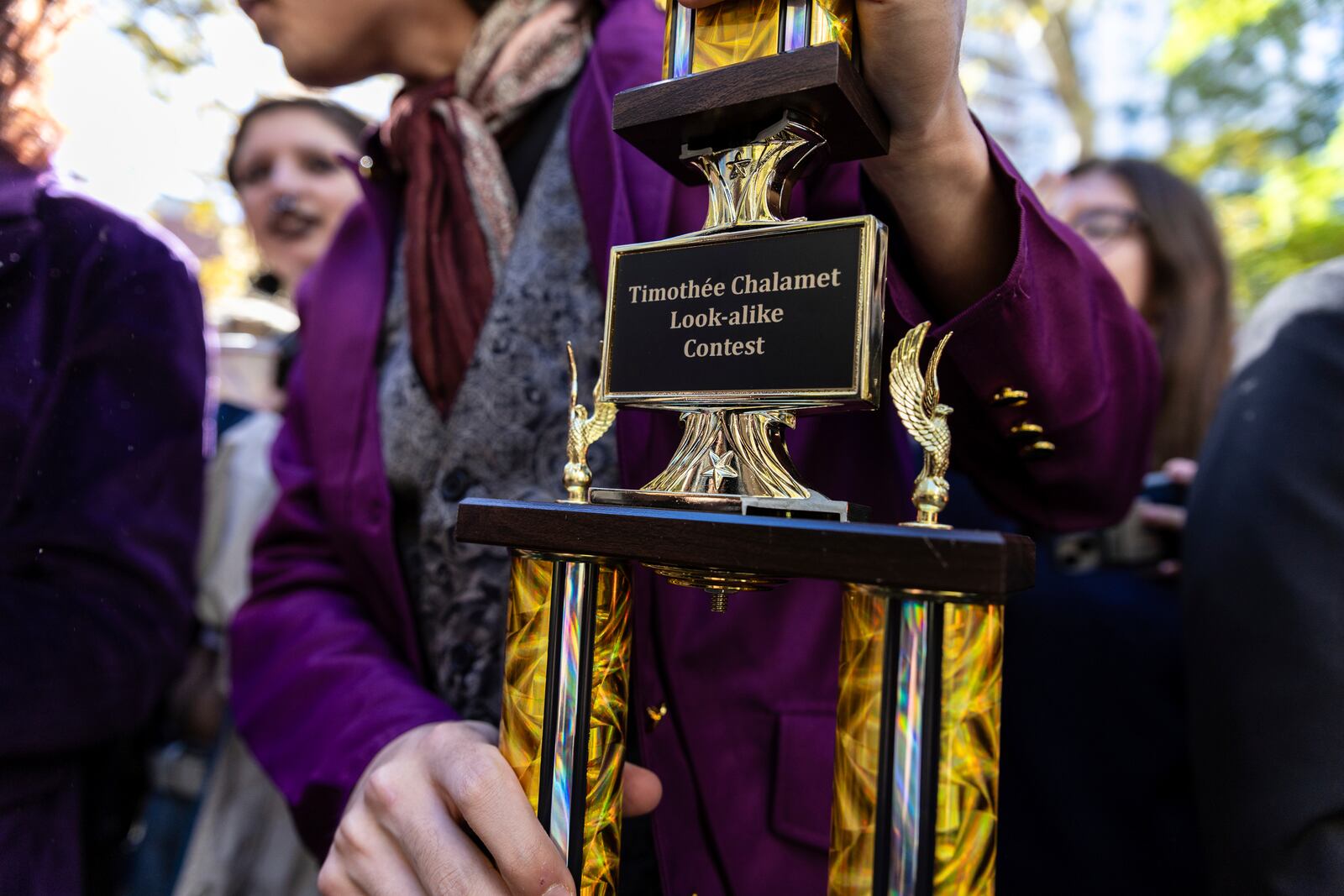 Miles Mitchell, 21, winner of the Timothee Chalamet lookalike contest, holds his trophy near Washington Square Park, Sunday, Oct. 27, 2024, in New York. (AP Photo/Stefan Jeremiah)