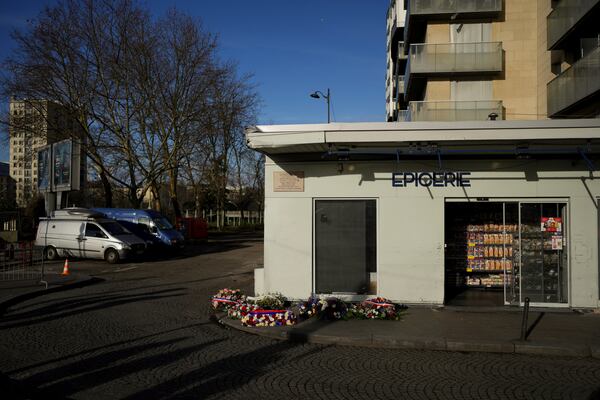 Wreaths lie in front of the Hypercacher Supermarket after commemorations marking 10 years since an Islamist attack on the Charlie Hebdo satirical newspaper and the Hypercacher jewish supermarket, in Paris Tuesday Jan. 7, 2025. (AP Photo/Thibault Camus)