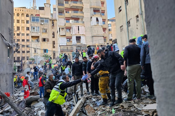 Rescuers search for victims at the site of an Israeli airstrike that targeted a building in Beirut, Lebanon, Tuesday, Nov. 26, 2024. (AP Photo/Hassan Ammar)