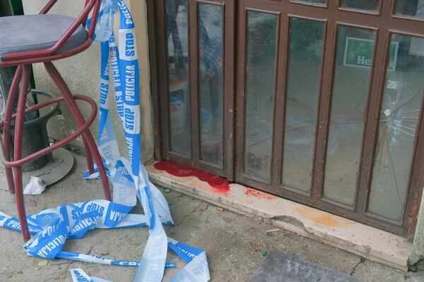 A view of blood by the door of a bar after a shooting incident, in Cetinje, 36 kilometers (22 miles) west of Podogrica, Montenegro, Thursday, Jan. 2, 2025. (AP Photo/Risto Bozovic)